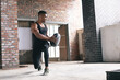 © Wavebreak Media - African american man exercising with a medicine ball in empty urban building