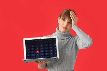 Wall Mural - Stressed young woman with laptop on color background. Concept of deadline