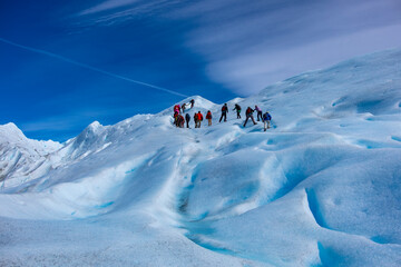 Walking with ice-axes on glacier