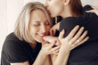 © prostooleh - Family at home. Grandmother with daughter and grandson. Women in a black t-shirts.