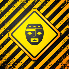 Canvas Print - Black Mexican mayan or aztec mask icon isolated on yellow background. Warning sign. Vector.