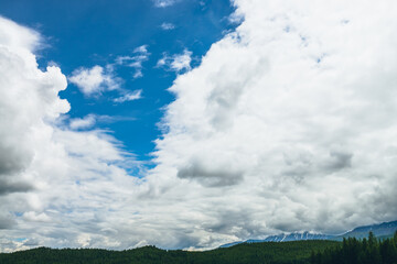 Wall Mural - scenic nature landscape with beautiful clouds in blue sky. colorful cloudscape with clouds above sno
