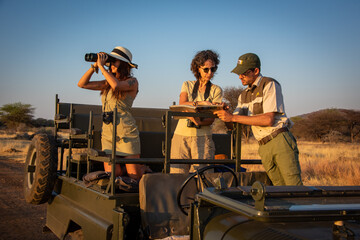 Poster - Guide and two women discuss wildlife sighting