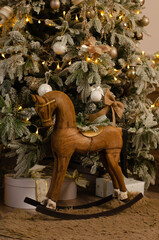 A wooden toy horse and a christmas tree 