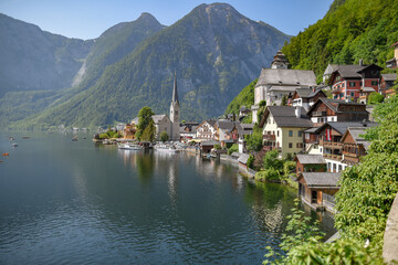 Poster - Beautiful shot of Hallstatt village in Austria surrounded by greenery-covered mountains