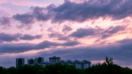 Wall Mural - beautiful colorful sunset in the city, sky with clouds, background, 16:9