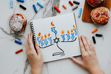 A Girl Drawing A Celebration Card With Menorah (traditional Candelabra) And Candles For Happy Hanukkah Jewish Holiday. 