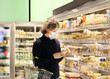 © lado2016 - supermarket shopping, face mask and gloves,man choosing frozen food from a supermarket freezer