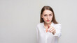 © Анастасия Семашко - Portrait of a angry young woman pointing finger at you camera gesture, white background, 16:9