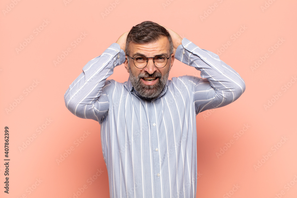 adult handsome man feeling stressed, worried, anxious or scared, with hands on head, panicking at mistake - obrazy, fototapety, plakaty 