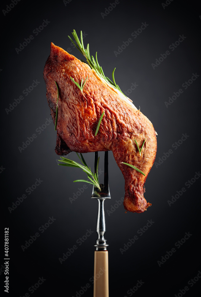 Smoked chicken thigh on a fork. - obrazy, fototapety, plakaty 