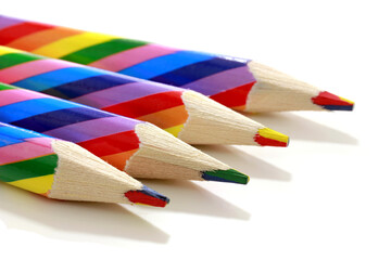 colored multicolored pencils for drawing on white background isolated, school kids