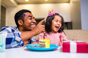 Wall Mural - single father and his little daughter celebration birth day in kitchen