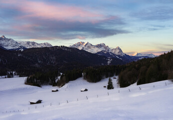 Wall Mural - beautiful sunrise in the mountains with snow covered huts in foreground - alps with alpspitze and zu