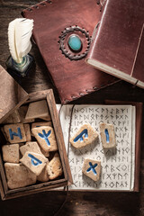 Wall Mural - Vintage book with futhark alphabet and runic stones