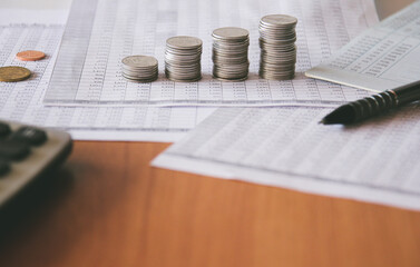 Stack of money coin on accounting sheet with selective focus, Business and financial concept. 