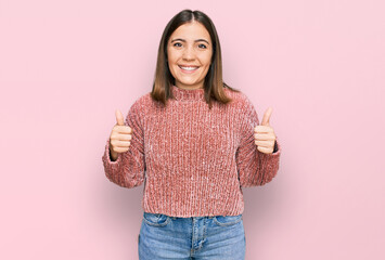 Poster - Young beautiful woman wearing casual clothes success sign doing positive gesture with hand, thumbs up smiling and happy. cheerful expression and winner gesture.