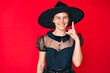 © Krakenimages.com - Young hispanic woman wearing witch halloween costume pointing finger up with successful idea. exited and happy. number one.