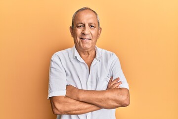 Wall Mural - Handsome mature man wearing casual white shirt happy face smiling with crossed arms looking at the camera. positive person.