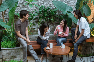 asian boys and girls laughing while having fun together at home garden