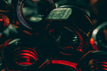 Sticker - Closeup shot of metal screws captured in a dark atmosphere with red lights coming under it