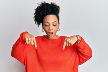 Young African American Girl Wearing Casual Clothes Pointing Down With Fingers Showing Advertisement, Surprised Face And Open Mouth