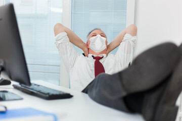 Wall Mural - Businessman relaxing in his office, covid concept