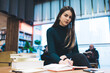 © GalakticDreamer - Smart young female studying at library
