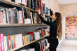 © GalakticDreamer - Student picking up books in bookstore