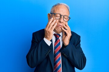 Poster - Senior caucasian man wearing business suit and tie tired hands covering face, depression and sadness, upset and irritated for problem