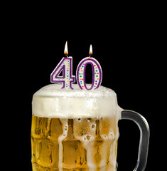 number 40 candles in beer mug for birthday celebration isolated on black 