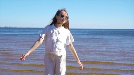 Wall Mural - Young beautiful girl having fun on tropical seashore.