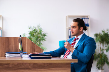 Young male employee working in the office