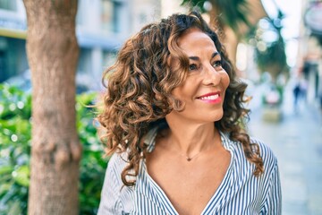 Poster - Middle age hispanic woman smiling happy walking at the city.