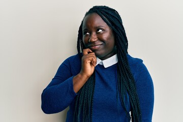 Poster - Young black woman with braids wearing casual clothes thinking concentrated about doubt with finger on chin and looking up wondering