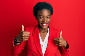 Young african american girl wearing business clothes success sign doing positive gesture with hand, thumbs up smiling and happy. cheerful expression and winner gesture.