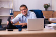 © Elnur - Young male employee doing physical exercises at workplace