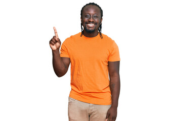 Sticker - Handsome young african american man wearing casual clothes showing and pointing up with finger number one while smiling confident and happy.