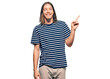 © Krakenimages.com - Handsome caucasian man with long hair wearing casual striped t-shirt with a big smile on face, pointing with hand and finger to the side looking at the camera.
