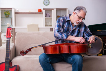 Senior male repairman repairing musical instruments at home