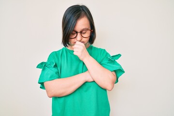 Canvas Print - Brunette woman with down syndrome wearing casual clothes and glasses feeling unwell and coughing as symptom for cold or bronchitis. health care concept.