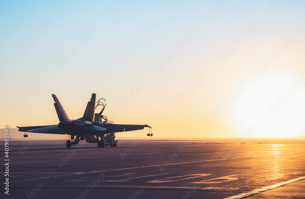 Jet fighter on an aircraft carrier deck against beautiful sunset sky . Elements of this image furnished by NASA - obrazy, fototapety, plakaty 