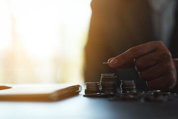 Wall Mural - people holding and stacking coins on the table