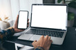© panitan - computer screen,cell phone blank mockup.hand woman work using laptop texting mobile.with white background for advertising,contact business search information on desk in cafe.marketing,design