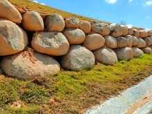 Natural Boulders Are Used As Retaining Walls Of Ground Banks That Have Been Embanked. Other Slopes Are Planted With Grass To Prevent Erosion Caused By Rain.
