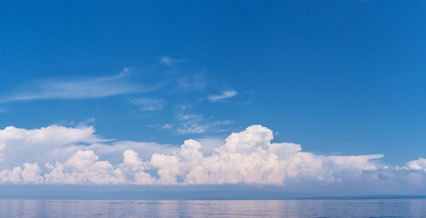 Wall Mural - calm sea and cloudy sky pierced with sun rays. beautiful nature background.