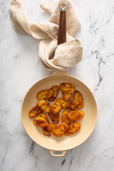 Wall Mural - Fried caramelized plantains in a cast iron pan