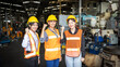 © Ron - Three female mechanical engineers or factory workers wearing hard hats and safety uniforms expressing their confidence with blurred factory background