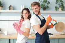 Young Happy Couple Is Having Fun While Doing Cleaning At Home.