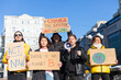 © Анастасия Каргаполов - A group of people with banners and a megaphone in hand are protesting in the city square for svae planet clean world act now